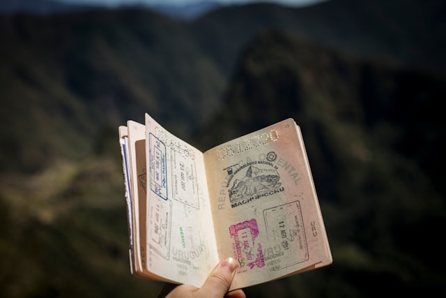 Requisitos para o visto mexicano: Encontre tudo o que você precisa para visitar o México 5 Uma pessoa segura um passaporte aberto para mostrar os carimbos de viagem.