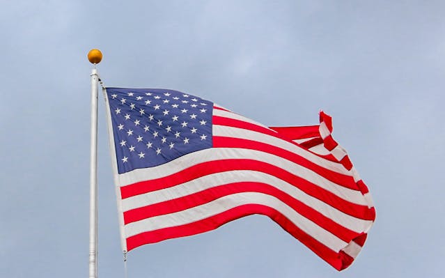 Documents de naturalisation : Quels sont les documents nécessaires ? 4 Un drapeau américain flotte au vent.