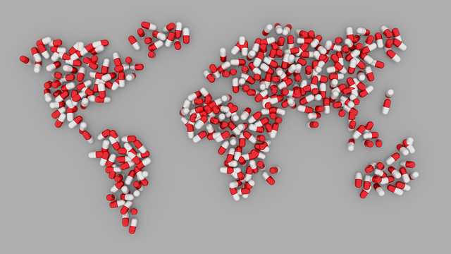 Services de traduction dans le domaine de la santé : Tout ce qu'ils impliquent 6 Illustration de la carte du monde avec des pilules cylindriques rouges et blanches.