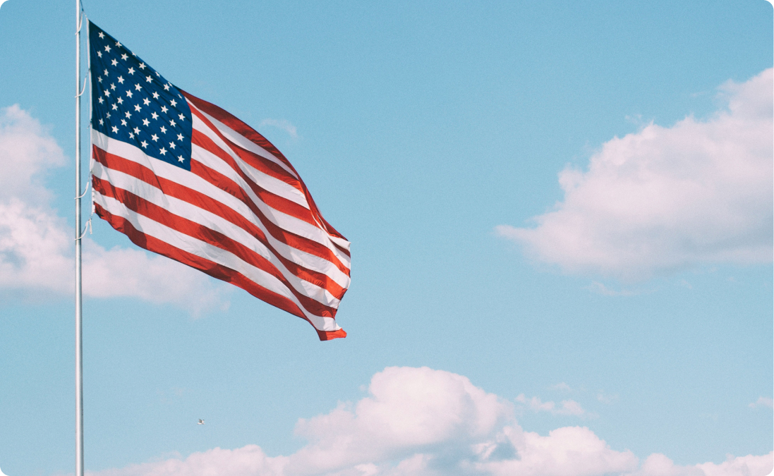American flag against blue sky background.