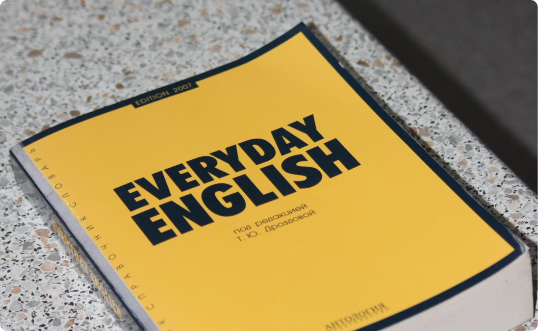 Yellow everyday English book with Russian text.