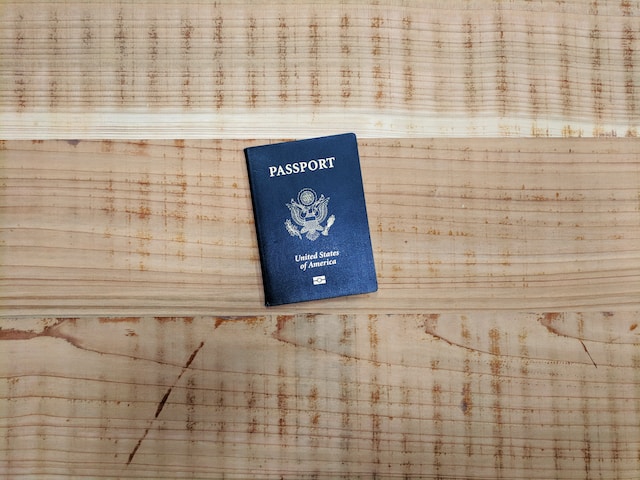 A passport on a wooden table.