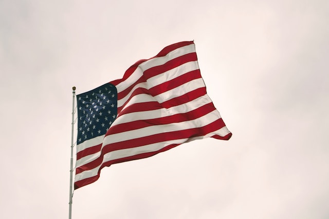 The US waving on a flag pole.