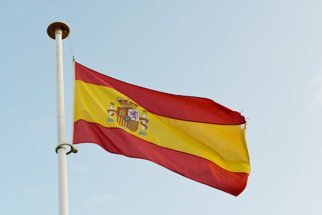 The Spanish flag flying on a flagpole.