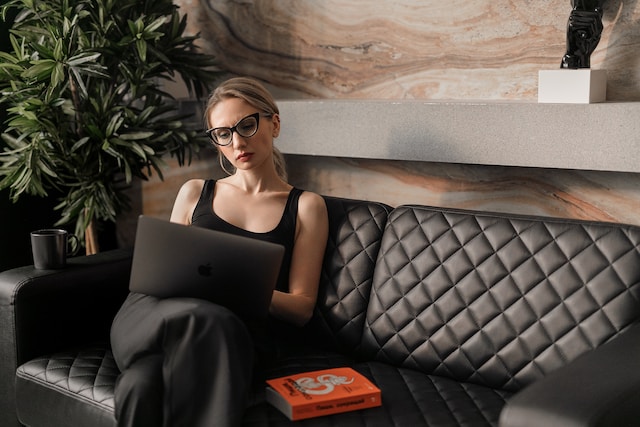 A woman reviews her translated document on her laptop.