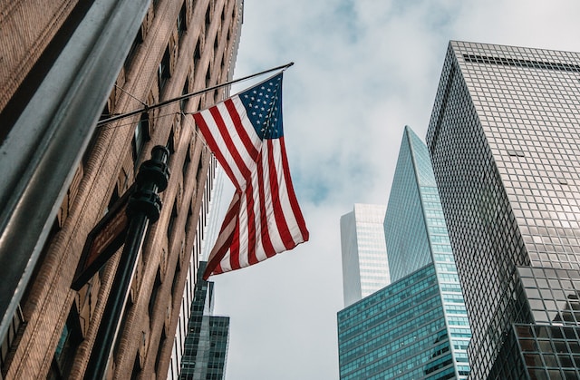 A US flag flying against an official building.