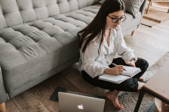 Woman writing in a notebook.

