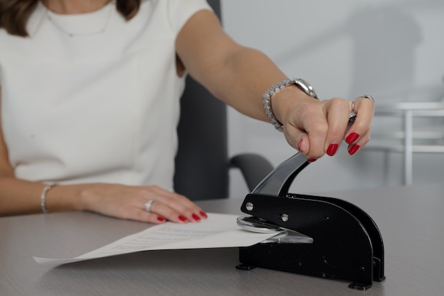 A businesswoman stamping a translated document.