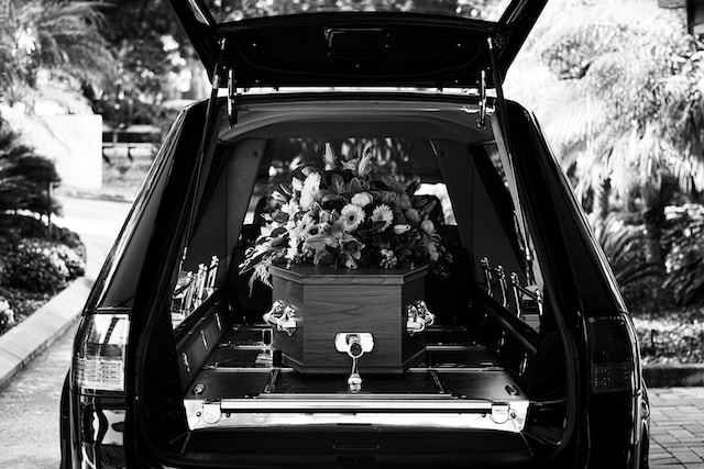 A coffin in the back of a hearse.