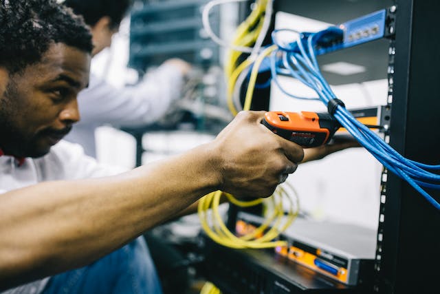 A picture of a person using an electric screwdriver.