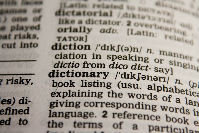 A closeup picture of a dictionary page with the definition of several words.