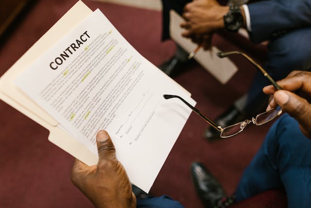 Close-up shot of a person holding a document of legal translations.
