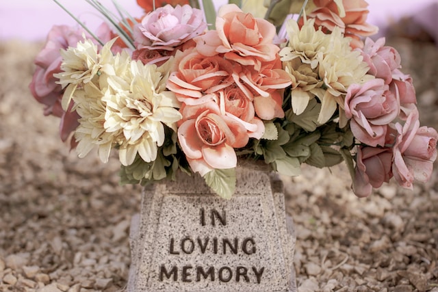 Faded flowers on a grave.