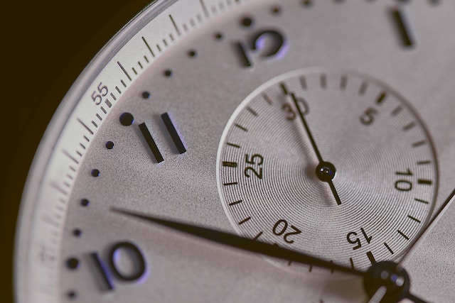A close-up image of the face of a silver watch.