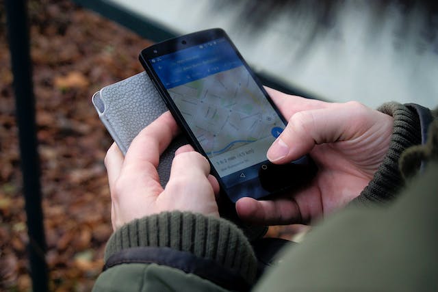 A picture of a person navigating Google Maps on a mobile device.