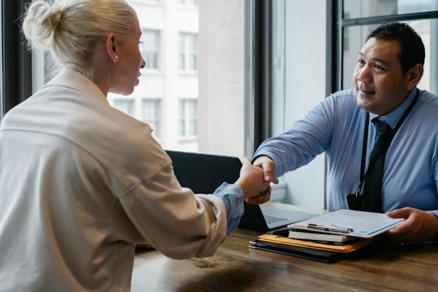 A picture of two people shaking hands in an office.