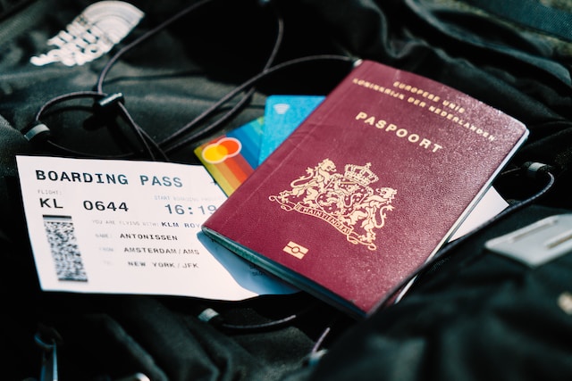 An image of a Netherlands passport and a boarding pass.