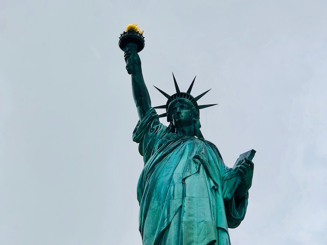 A picture of the Statue of Liberty with a clear skyline behind.