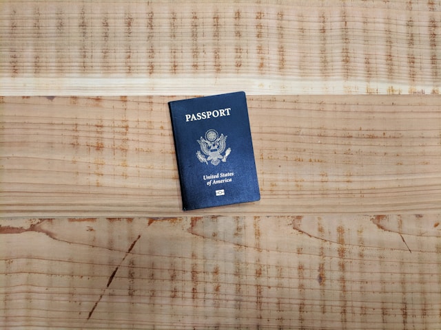 The United States of America travel passport book on a wooden surface.
