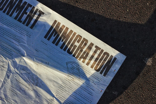 A white printed paper boldly titled “IMMIGRATION.”
