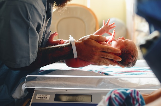 Translate Birth Certificate to English: The Ultimate Guide 3 A nurse placing a newborn on a scale.
