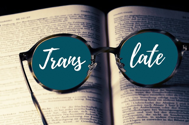 Eyeglasses on a book with the word “Translate” split between both lenses.
