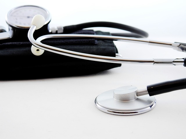 A stethoscope leans on a white surface.
