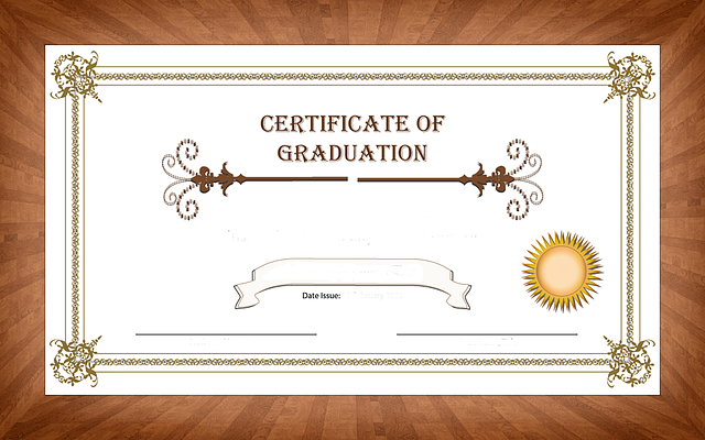 A graduation certificate template is on a wooden table.
