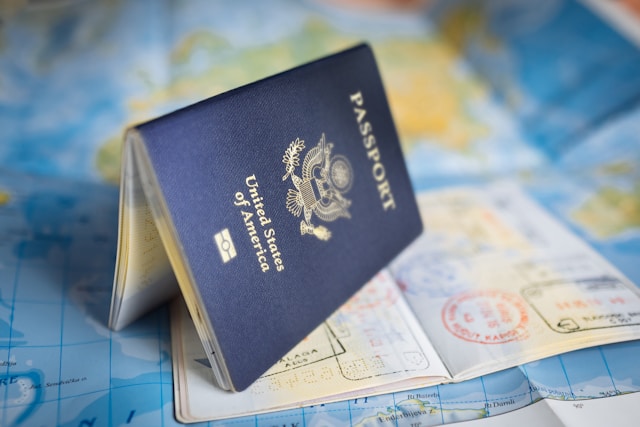 An opened American passport is on a map.
