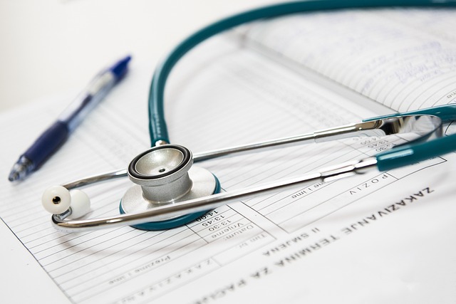 A close-up view of a stethoscope and pen on a printed page.
