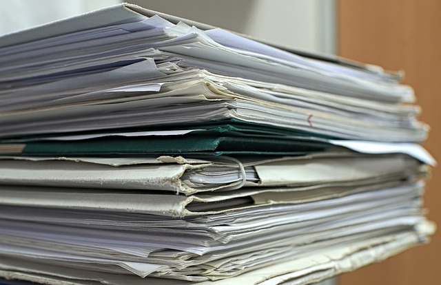 A stack of folders contains old documents.
