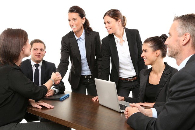 A group of people interact in an office.
