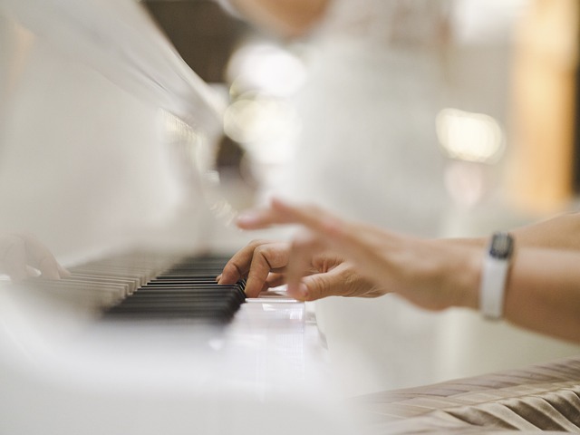 A person presses the keys of a piano.
