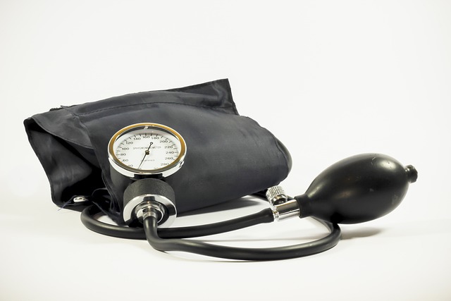 A manual blood pressure monitor on a white surface.
