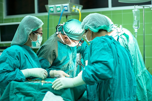 Surgeons in operating gowns surround an operating table.

