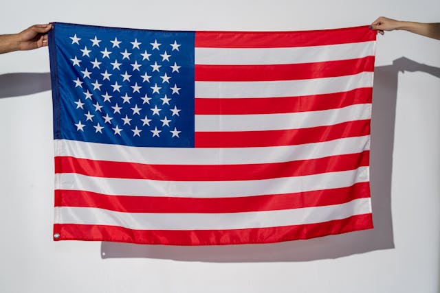 Translation Service Agency: A Source of Language Solutions 5 Two people hold the American flag.