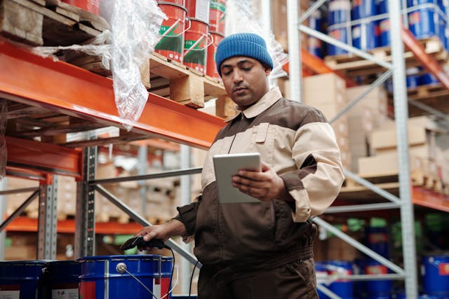 Employee Handbook Translation: How To Get This Service 3 A person looks at a tablet while working.