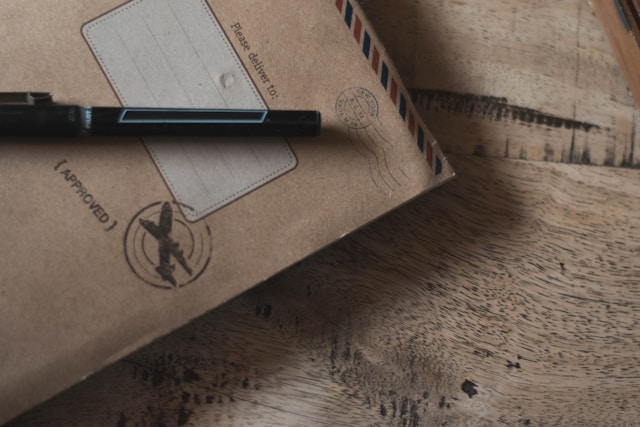 What Is a Notarized Translation? Why Is It Important? 4 A brown envelope on a table with an approval stamp and a pen.