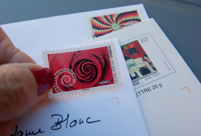 Can I Get a Birth Certificate Same Day? How Possible Is It? 6 Someone holds several mailed packages with stamps.