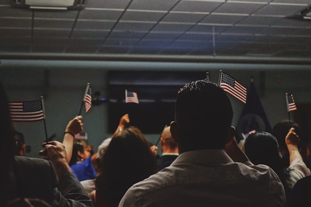 How To Marry a Non-US Citizen 4 A group of people holds miniature versions of the U.S. flag.