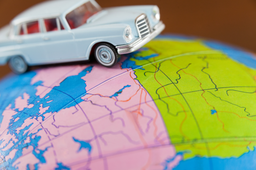 Can You Drive in the U.S. With a Foreign License? (2026 Guide) 3 Miniature car on a map.